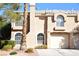 Inviting two-story home with arched windows and a well-manicured front yard at 9672 Gunsmith Dr, Las Vegas, NV 89123