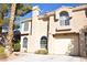 Inviting two-story home with arched windows and a manicured front yard at 9672 Gunsmith Dr, Las Vegas, NV 89123
