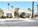 Charming single-story home with large windows, desert landscaping, and a well manicured lawn at 9672 Gunsmith Dr, Las Vegas, NV 89123