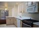 Well-lit kitchen with white countertops and modern appliances with view into adjacent living area at 9672 Gunsmith Dr, Las Vegas, NV 89123