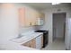 Bright kitchen features ample cabinet space, white countertops and modern appliances at 9672 Gunsmith Dr, Las Vegas, NV 89123