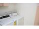 Laundry room featuring white washer and dryer units and overhead shelving at 9672 Gunsmith Dr, Las Vegas, NV 89123