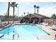 Community pool with clear blue water, poolside clubhouse, and plenty of seating at 9672 Gunsmith Dr, Las Vegas, NV 89123