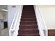 Staircase with carpeted steps and white railings leading to the upper level at 9672 Gunsmith Dr, Las Vegas, NV 89123