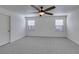 Bedroom features neutral color palette, carpet floors, two windows and a ceiling fan at 10581 Griffin Ave, Las Vegas, NV 89129