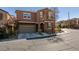 A two-story home features a stucco exterior, an attached garage, and low-maintenance landscaping at 10581 Griffin Ave, Las Vegas, NV 89129