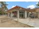 A covered patio includes chairs and a grill, perfect for relaxing and entertaining guests at 1093 Morning Sun Way, Las Vegas, NV 89110