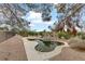 This backyard offers a unique pool, enhancing the natural beauty of the desert landscape at 1093 Morning Sun Way, Las Vegas, NV 89110