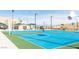 Vibrant blue and green basketball court with multiple hoops, perfect for sports and recreation at 11237 Gallery Echo St, Las Vegas, NV 89141
