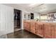 Bathroom boasts wood cabinets, a double sink, and a sliding door closet, providing ample storage and convenience at 11237 Gallery Echo St, Las Vegas, NV 89141