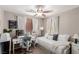 Bedroom with a ceiling fan, a trundle bed, a desk, carpet flooring, and bright natural light at 11237 Gallery Echo St, Las Vegas, NV 89141
