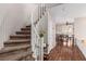 Welcoming foyer featuring a winding staircase and elegant hardwood floors at 11237 Gallery Echo St, Las Vegas, NV 89141