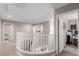 Upstairs hallway with a white staircase, carpet flooring, and views into an office and storage room at 11237 Gallery Echo St, Las Vegas, NV 89141