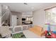 Bright living room featuring a staircase, playroom area, and seamless flow into the cozy seating area at 11237 Gallery Echo St, Las Vegas, NV 89141