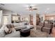 Bright open-concept living room with tile flooring and plush seating at 11237 Gallery Echo St, Las Vegas, NV 89141