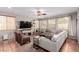 Comfortable living room featuring large windows, plush seating, and modern decor at 11237 Gallery Echo St, Las Vegas, NV 89141