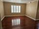 Bedroom with rich hardwood floors and window with plantation shutters at 1150 N Buffalo Dr # 1015, Las Vegas, NV 89128