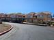 Exterior of building with covered parking, neutral tones, and community landscaping at 1150 N Buffalo Dr # 1015, Las Vegas, NV 89128