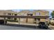 Exterior view of building with assigned covered parking, trimmed landscaping, and neutral colored facade at 1150 N Buffalo Dr # 1015, Las Vegas, NV 89128