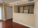 Open concept living area showcasing hardwood floors and an adjacent kitchen at 1150 N Buffalo Dr # 1015, Las Vegas, NV 89128