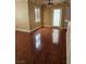Living room featuring hardwood floors, neutral walls, fan, and access to a patio at 1150 N Buffalo Dr # 1015, Las Vegas, NV 89128