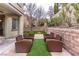 Inviting backyard with ample seating on artificial turf and well-maintained walls, offering a tranquil outdoor escape at 11820 Calle De Sol Dr, Las Vegas, NV 89138