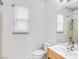 Bright bathroom with white cabinets, a large mirror, and plenty of natural light at 11820 Calle De Sol Dr, Las Vegas, NV 89138