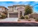 Charming two-story home boasts a well-maintained front yard and attached two-car garage, providing ample parking at 11820 Calle De Sol Dr, Las Vegas, NV 89138