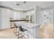 Bright kitchen features white cabinetry, stainless steel appliances, and a center island with seating, perfect for entertaining at 11820 Calle De Sol Dr, Las Vegas, NV 89138