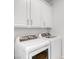 The laundry room features a front loading washing machine and dryer along with white cabinets at 11820 Calle De Sol Dr, Las Vegas, NV 89138