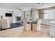Open-concept living area featuring a cozy fireplace, dining area, and ample natural light at 11820 Calle De Sol Dr, Las Vegas, NV 89138