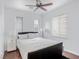 A spacious main bedroom with a ceiling fan, natural light, and a hardwood floor at 11820 Calle De Sol Dr, Las Vegas, NV 89138