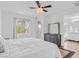 Bright main bedroom with a ceiling fan, en-suite bathroom access and view to outside, creating an airy, comfortable space at 11820 Calle De Sol Dr, Las Vegas, NV 89138