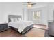 Spacious main bedroom with dark wood floors, a ceiling fan, and a plush bed, creating a relaxing and comfortable retreat at 11820 Calle De Sol Dr, Las Vegas, NV 89138