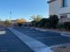Paved parking lot, painted parking spaces, and curb stops against landscaping in front of the building at 11820 Calle De Sol Dr, Las Vegas, NV 89138