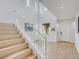 Elegant staircase leading to the second floor, complemented by natural light and neutral tones at 11820 Calle De Sol Dr, Las Vegas, NV 89138