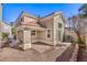 Beige home featuring an enclosed brick patio area and low-maintenance gravel landscaping in the backyard at 1425 Bow Creek Ct, Las Vegas, NV 89128