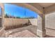 Enclosed backyard with low brick borders, gravel ground cover and covered patio at 1425 Bow Creek Ct, Las Vegas, NV 89128