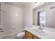 Clean bathroom features a shower-tub combo, white tiled walls, and vanity with mirror at 1425 Bow Creek Ct, Las Vegas, NV 89128