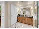 Bathroom with double sink vanity, large mirror, tiled floor, and glass enclosed shower at 145 E Harmon Ave # 2917, Las Vegas, NV 89109