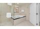 Bathroom features a glass enclosed shower and an adjacent soaking tub at 145 E Harmon Ave # 2917, Las Vegas, NV 89109