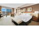 Comfortable hotel suite offering a king-sized bed, seating area, and expansive windows with city views at 145 E Harmon Ave # 2917, Las Vegas, NV 89109