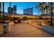 Relaxing patio with seating areas, lush greenery, and views of nearby buildings at 145 E Harmon Ave # 2917, Las Vegas, NV 89109