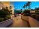 Outdoor patio area with string lights, comfortable seating, and lush landscaping at 145 E Harmon Ave # 2917, Las Vegas, NV 89109