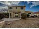 Large backyard featuring a covered patio area, desert landscaping, and a two-story home exterior at 172 Cloudcrest Dr, Henderson, NV 89015