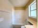 Cozy bathroom featuring tub-shower combo with safety bars and a window at 172 Cloudcrest Dr, Henderson, NV 89015