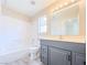 Bathroom boasts shower-tub combo, gray vanity, and a framed mirror at 172 Cloudcrest Dr, Henderson, NV 89015