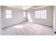 Spacious bedroom with neutral carpeting, multiple windows, and a ceiling fan at 172 Cloudcrest Dr, Henderson, NV 89015