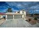 Charming home featuring a two-car garage with a spacious driveway and simple desert landscaping at 172 Cloudcrest Dr, Henderson, NV 89015