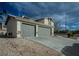 Charming home featuring a two-car garage with a spacious driveway and simple desert landscaping at 172 Cloudcrest Dr, Henderson, NV 89015
